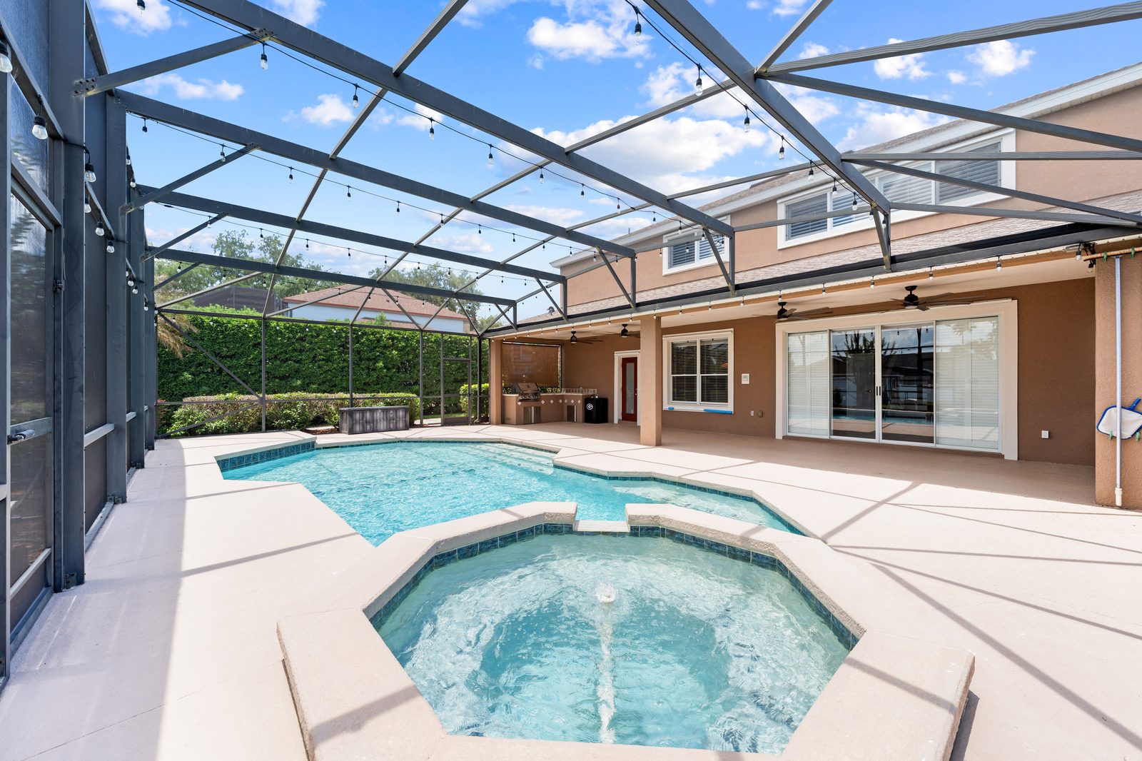 Pool and covered lanai along the back of the home
